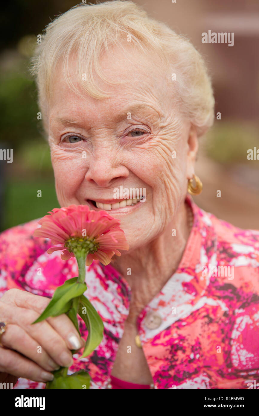 Close Up Of Woman Smelling Flowers Stock Photo