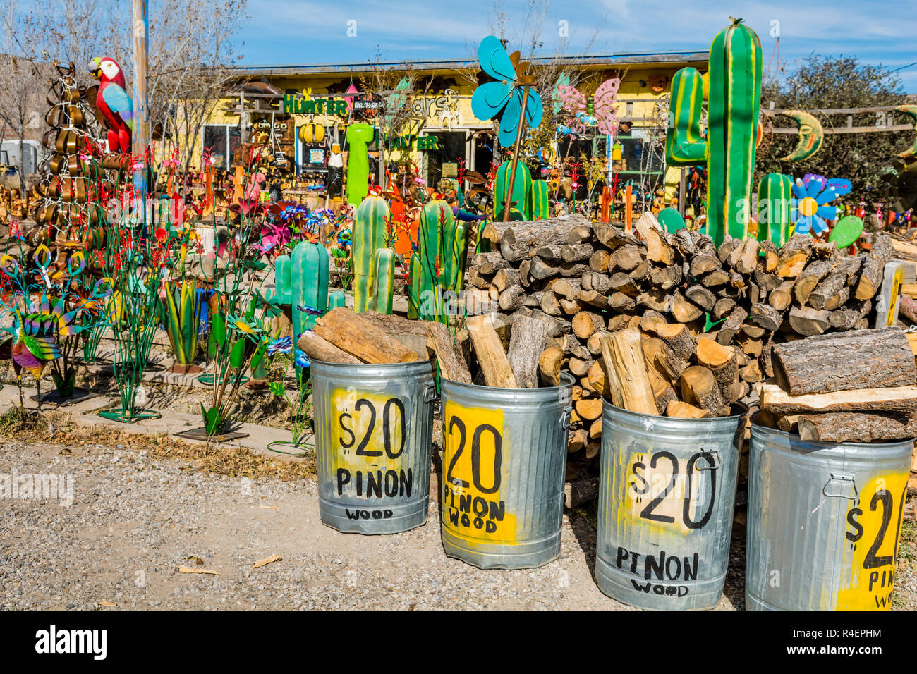 Ruidoso, New Mexico, USA, piñon wood, piñon firewood for sale at a shop selling colorful Mexican metal imports. Stock Photo