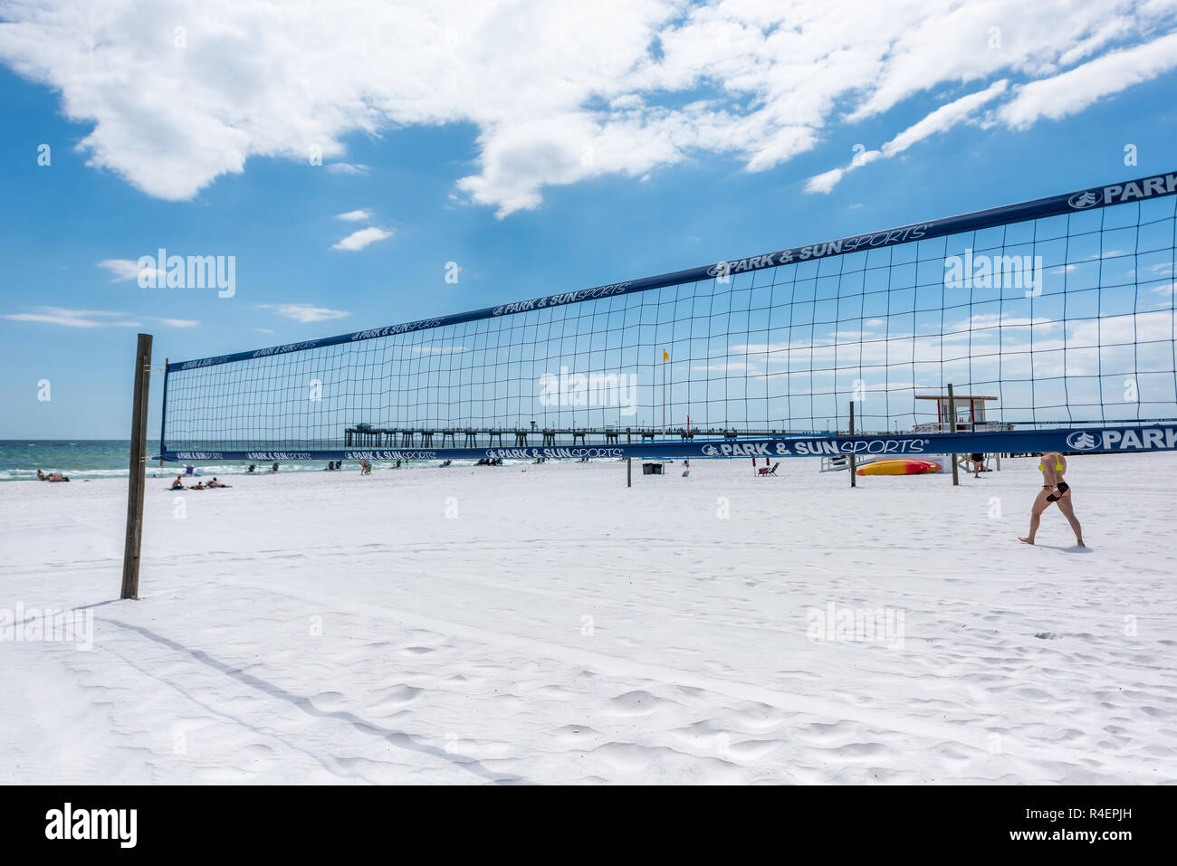 Fort Walton Beach, USA - April 24, 2018: Okaloosa Island fishing pier in Florida in Panhandle, Gulf of Mexico during sunny day, sand beach volleyball  Stock Photo