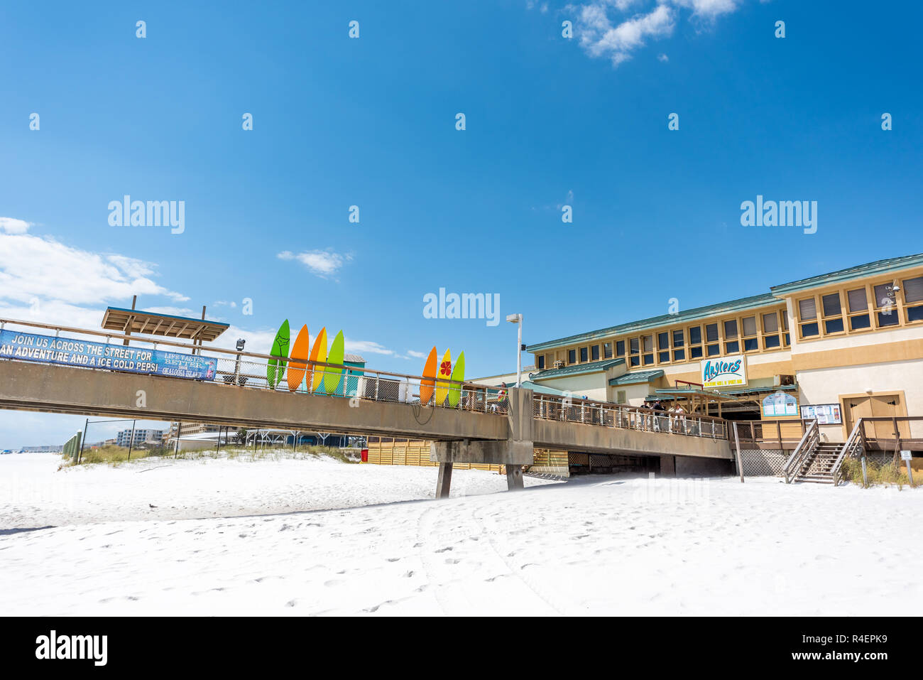 Fort Walton Beach, USA - April 24, 2018: Okaloosa Island fishing pier in Florida in Panhandle, Gulf of Mexico during sunny day, colorful surfboards, r Stock Photo