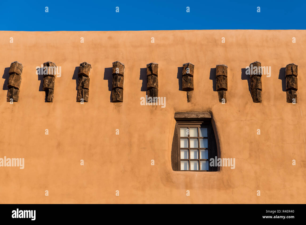 Adobe Building Windows Pueblo style adobe building wall and rustic wood-framed window and beam ...