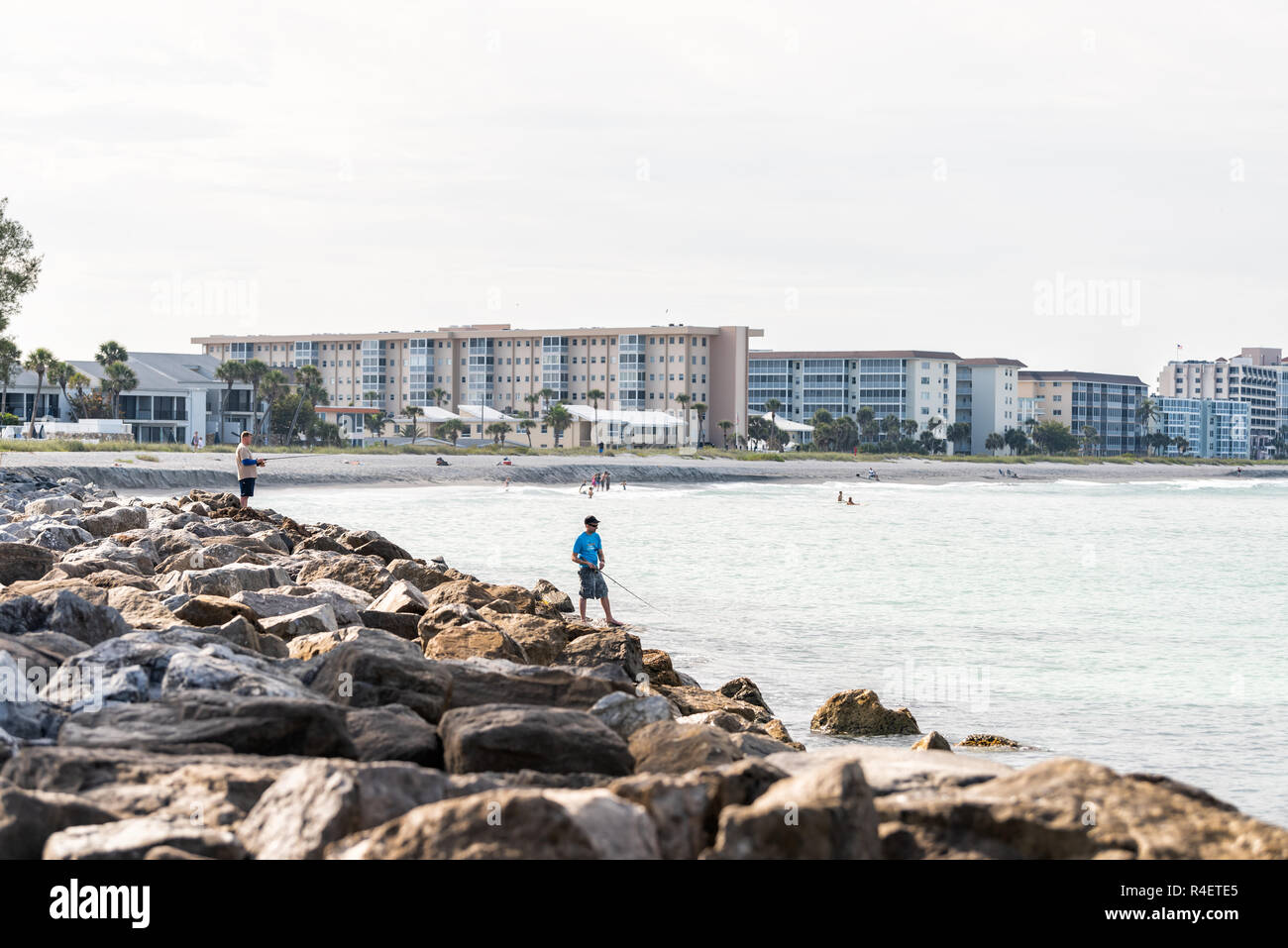 Venice, USA - April 29, 2018: Holiday vacation homes in small Florida retirement beach city, town, or village architecture, in gulf of Mexico, people  Stock Photo