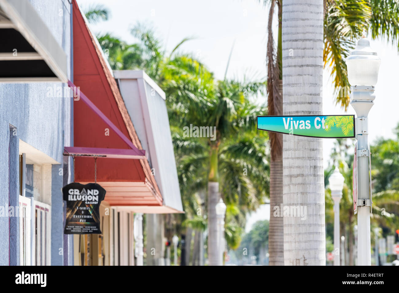 Fort Myers, USA - April 29, 2018: City town sidewalk street during sunny day in Florida gulf of mexico coast, shopping, sign for Vivas Court colorful  Stock Photo