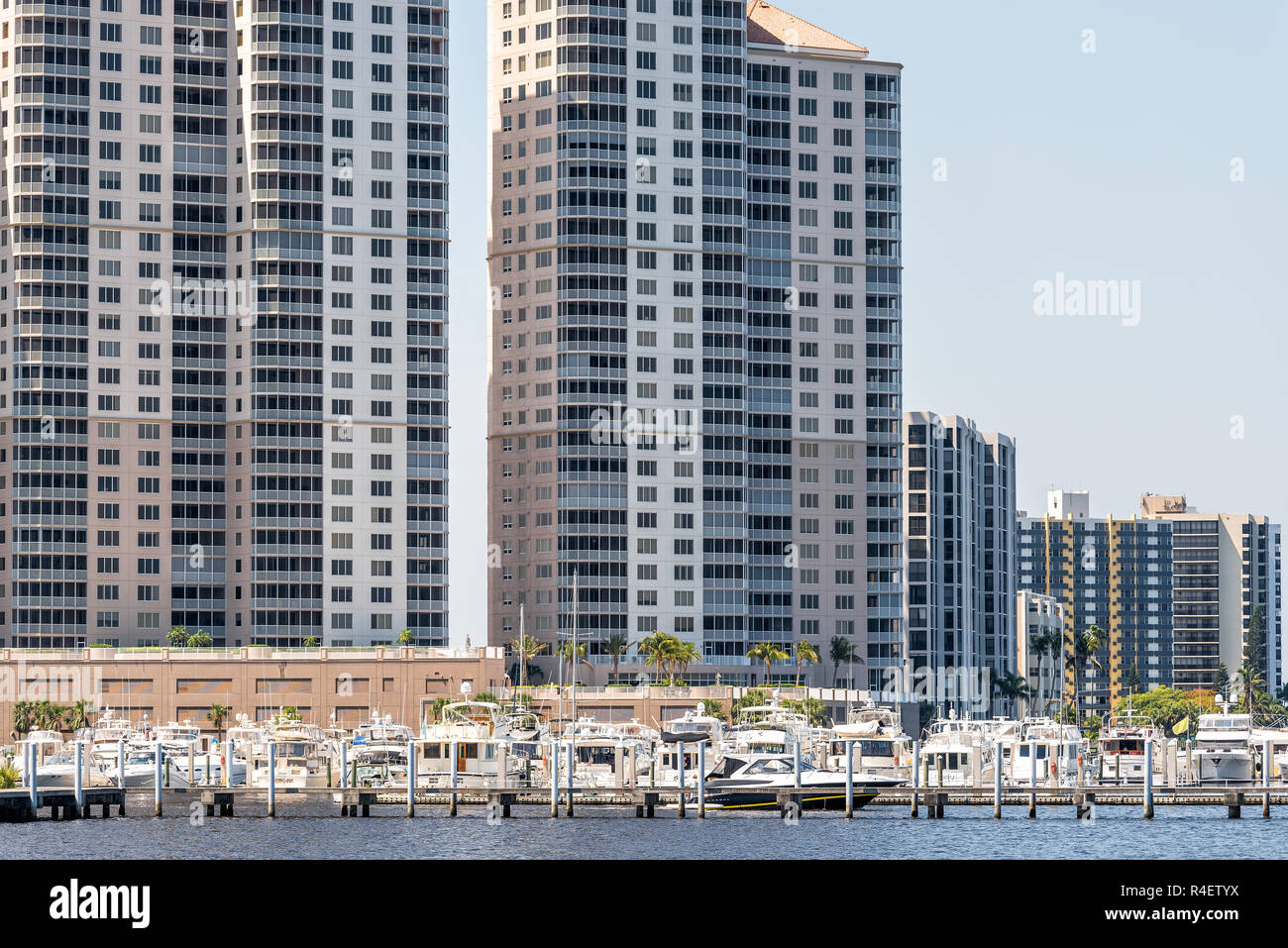Fort Myers, USA - April 29, 2018: Boats in marina harbor dock on Caloosahatchee River during sunny day in Florida gulf of mexico coast, apartment cond Stock Photo