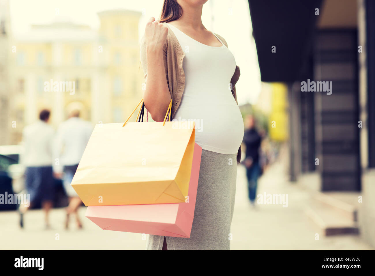 pregnant woman with shopping bags at city street Stock Photo Alamy