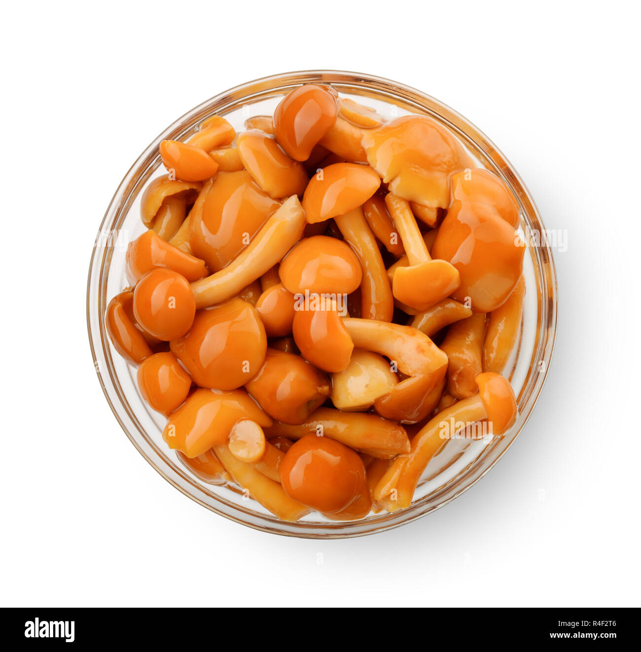 Top view of pickled mushrooms in glass bowl isolated on white Stock Photo