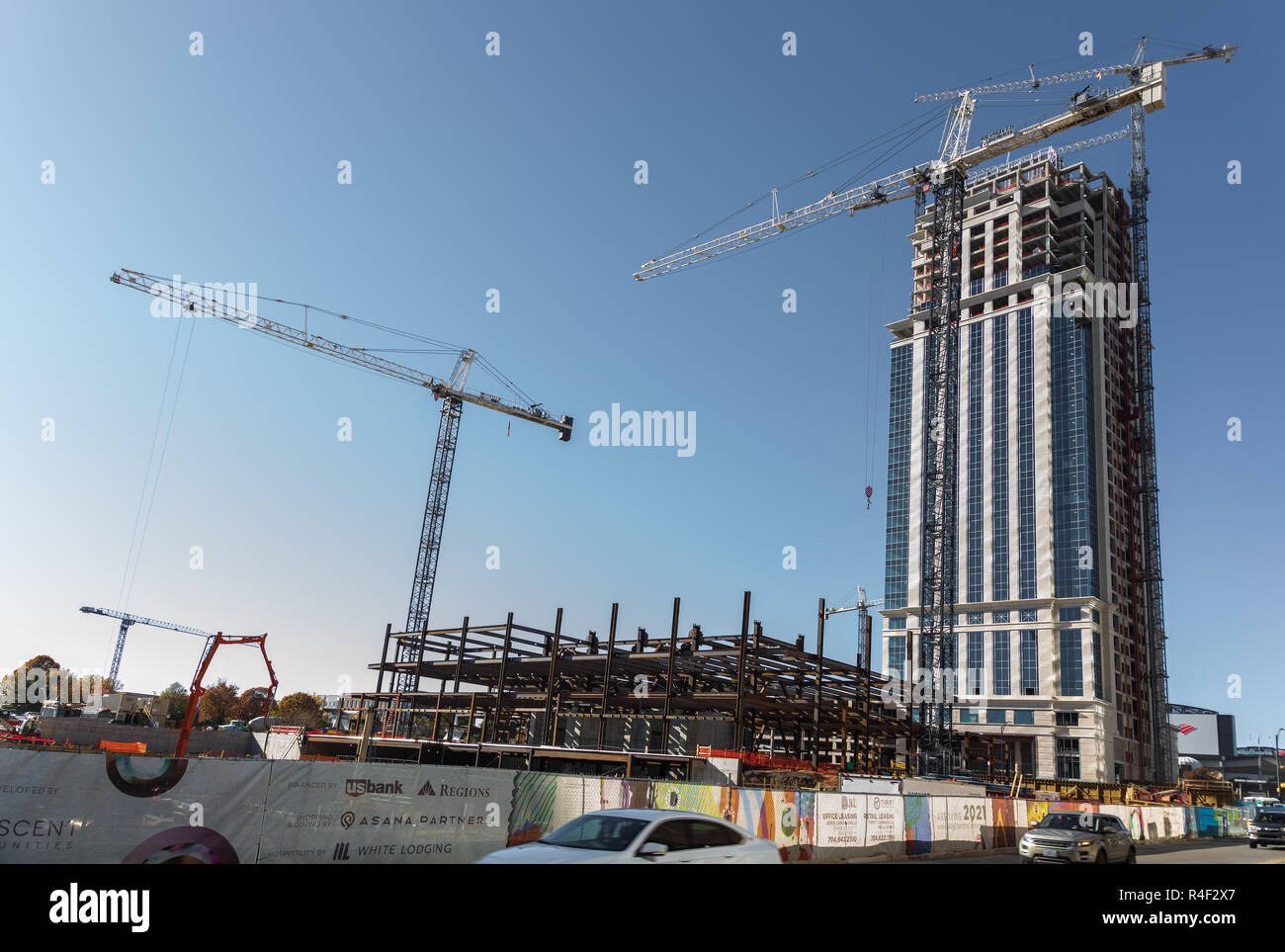 CHARLOTTE, NC, USA-11/21/18:  Five construction cranes at the new buildings in front of the Carolina Panthers stadium. Stock Photo