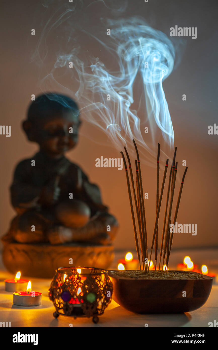 Burning incense sticks.Incense is used for aesthetic reasons, and in therapy, meditation, and ceremony. It may also be used as a simple deodorant or i Stock Photo