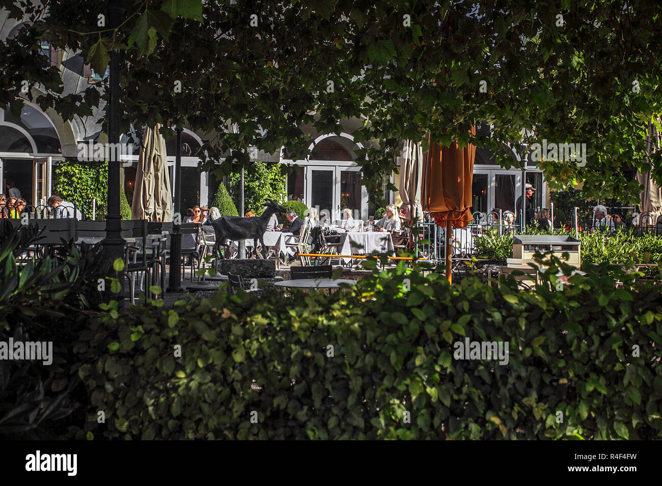 Clientele eating outside on the veranda of The Seehaus Restaurant in the English Garden of Munich, Germany. Stock Photo