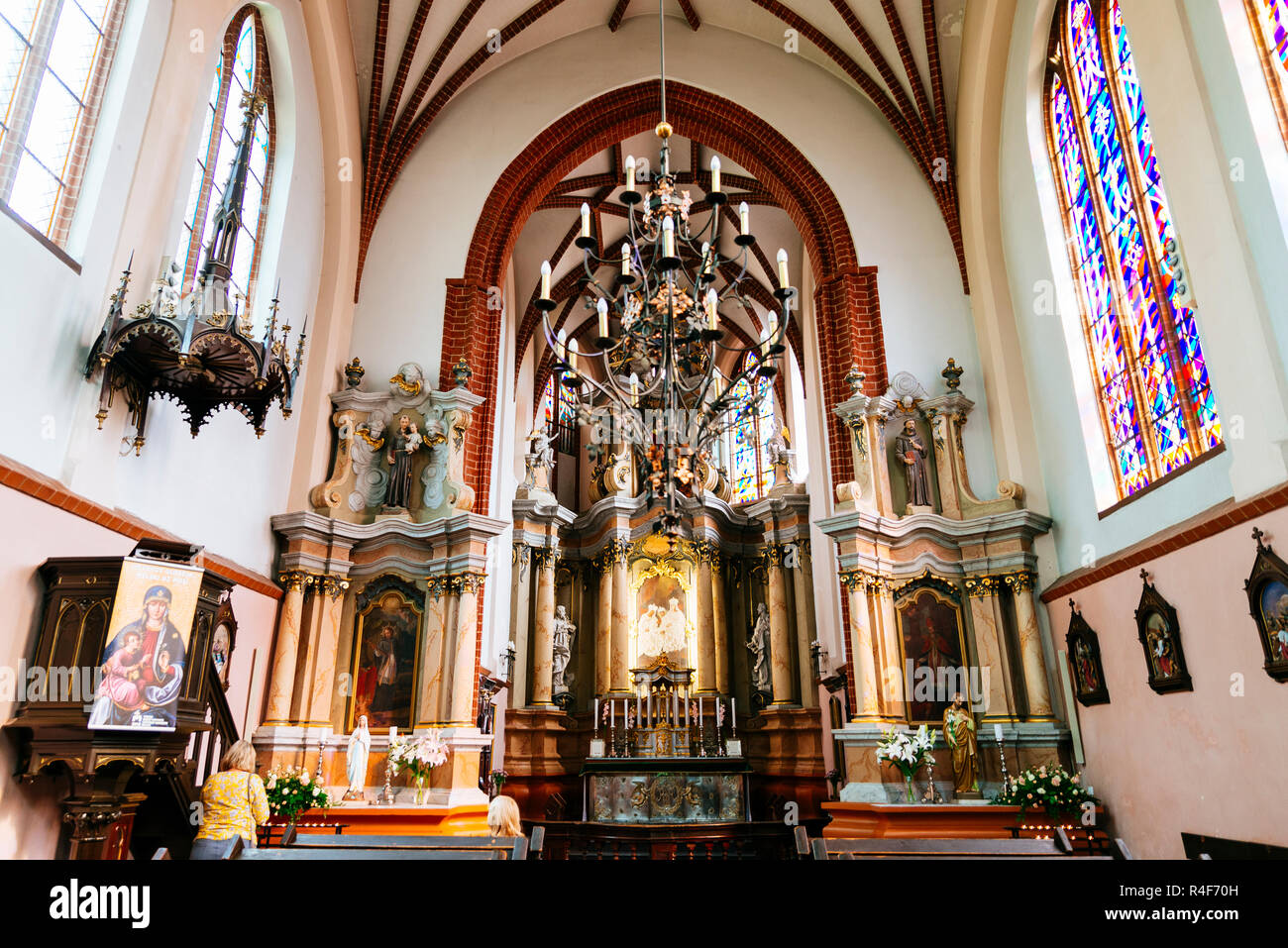 Nave and main altar, St. Anne's Church is a Roman Catholic church in Vilnius Old Town. It is a prominent example of both Flamboyant Gothic and Brick G Stock Photo