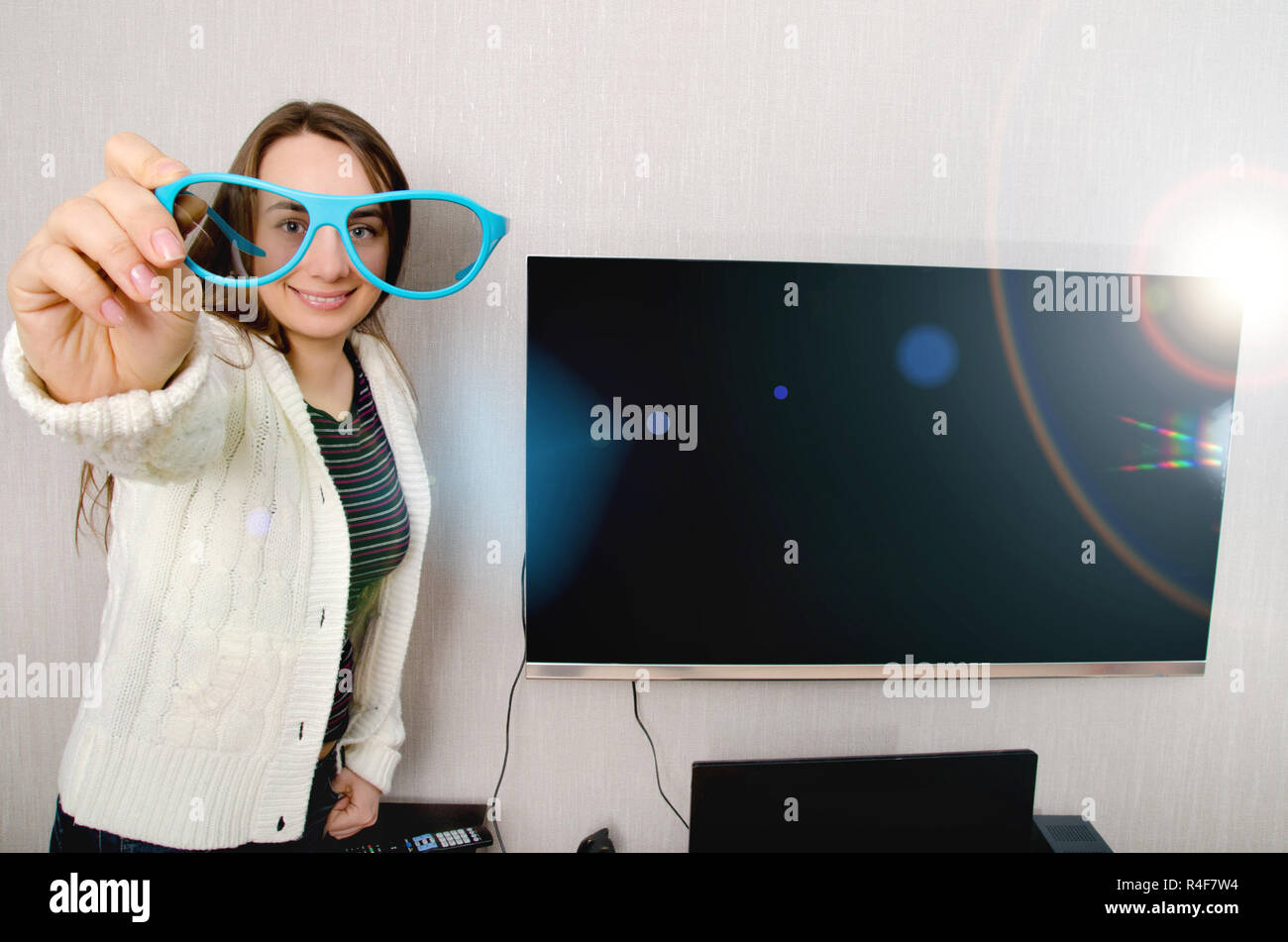 woman in 3d glasses with tv indoors Stock Photo