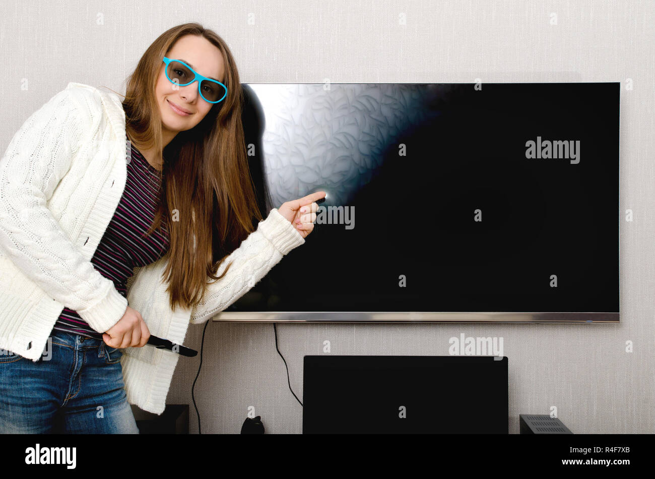 woman in 3d glasses with tv indoors Stock Photo