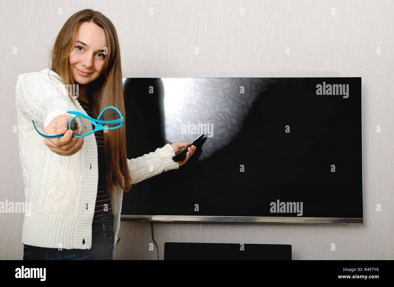 woman in 3d glasses with tv indoors Stock Photo