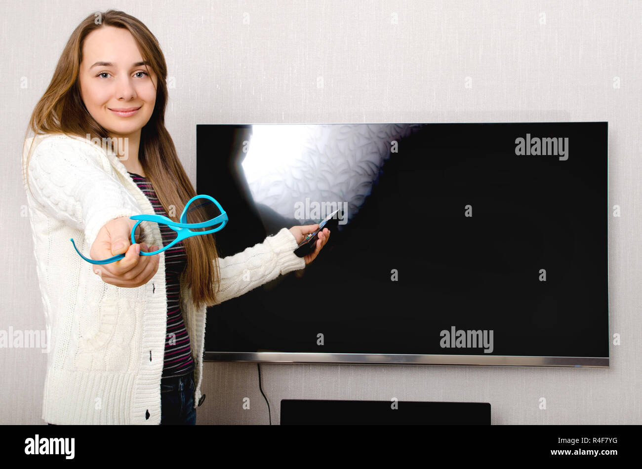 woman in 3d glasses with tv indoors Stock Photo