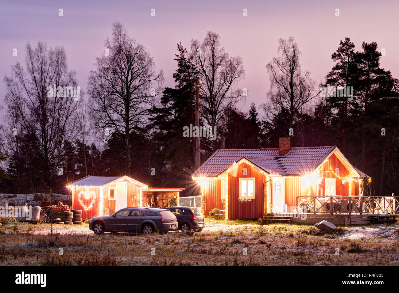 Christmas decorated and lit Swedish house at night Stock Photo