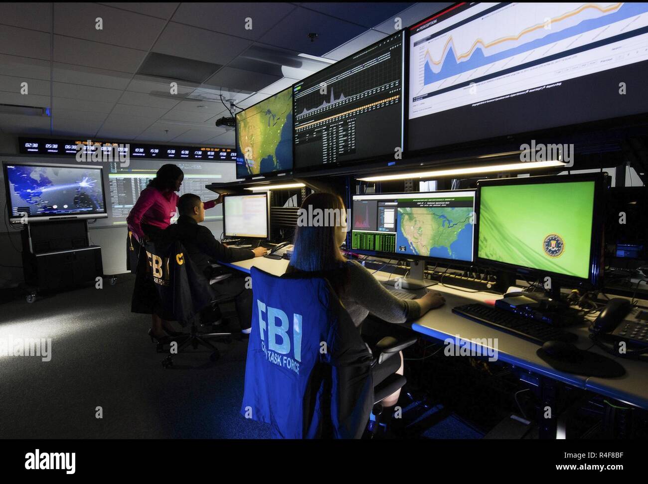 Federal Bureau of Investigation - FBI -agents work at computer in the bureau's cyber crimes division. The FBI Cyber Division is a Federal Bureau of Investigation division which heads the national effort to investigate and prosecute internet crimes, including 'cyber based terrorism, espionage, computer intrusions, and major cyber fraud.' This division of the FBI uses the information it gathers during investigation to inform the public of current trends in cyber crime.Federal Bureau of Investigation It focuses around three main priorities: computer intrusion, identity theft, and cyber fraud. Stock Photo