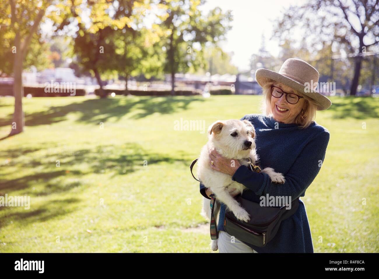 Old Woman Holding a Dog Stock Photo