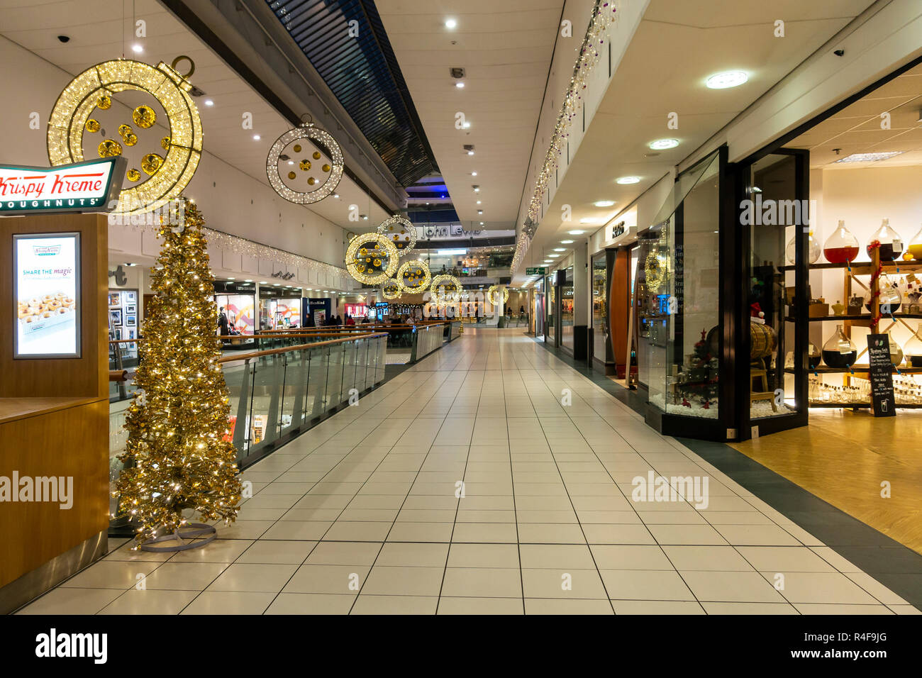 A section of Buchan Galleries shopping mall in the centre of Glasgow, Scotland, decorated for Christmas. Kristy Kreme, gold Christmas tree, John Lewis Stock Photo