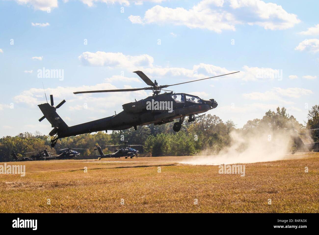 An AH-64D Apache with 1st Attack Reconnaissance Battalion, 82nd Combat Aviation Brigade, kicks up dust as it approaches the forward arming and refueling point after executing an aerial gunnery exercise, at Fort A.P. Hill, Va., Oct. 24. Stock Photo