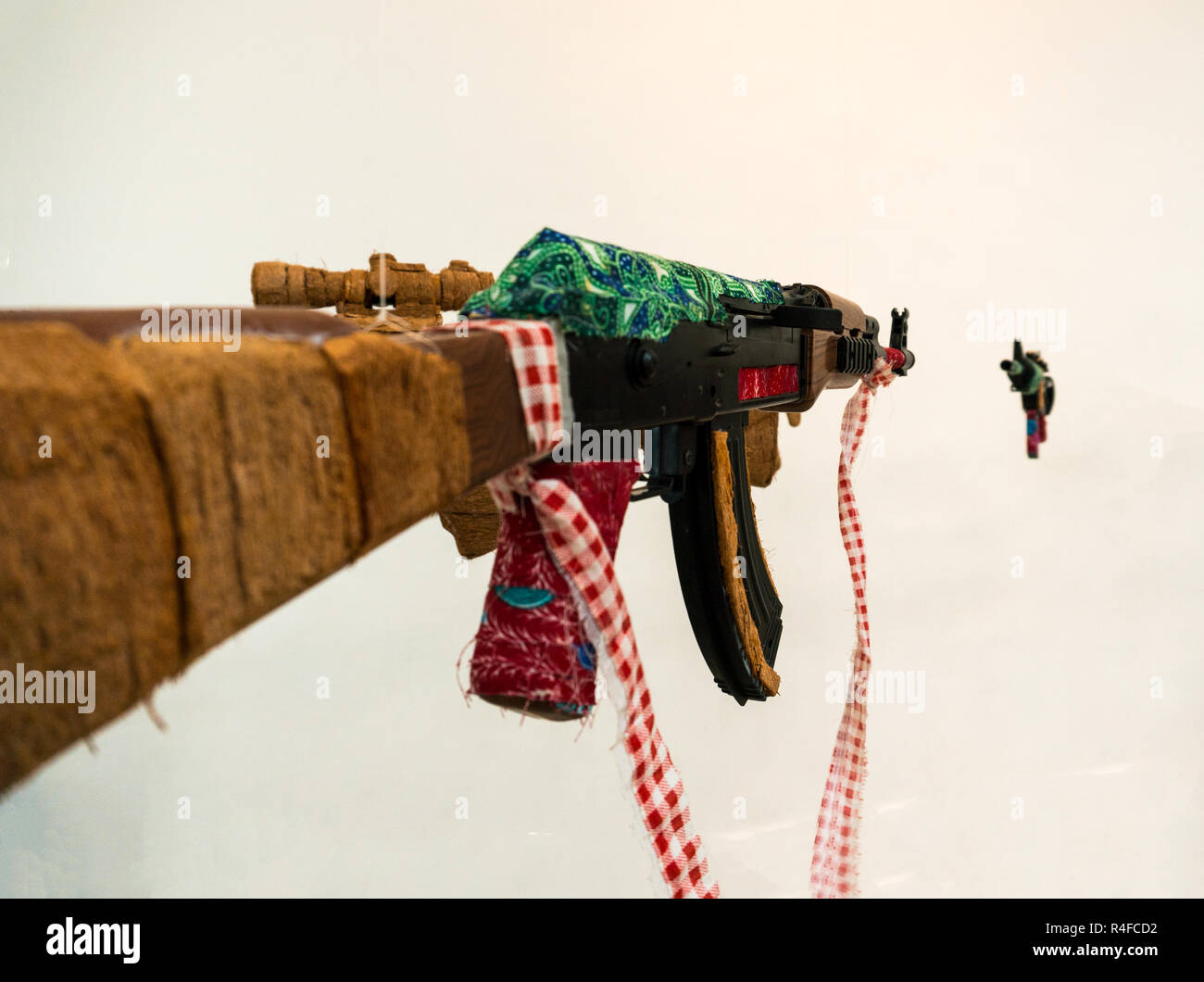 Fake AK Kalashnikov assault rifle hanging on white background Stock Photo -  Alamy