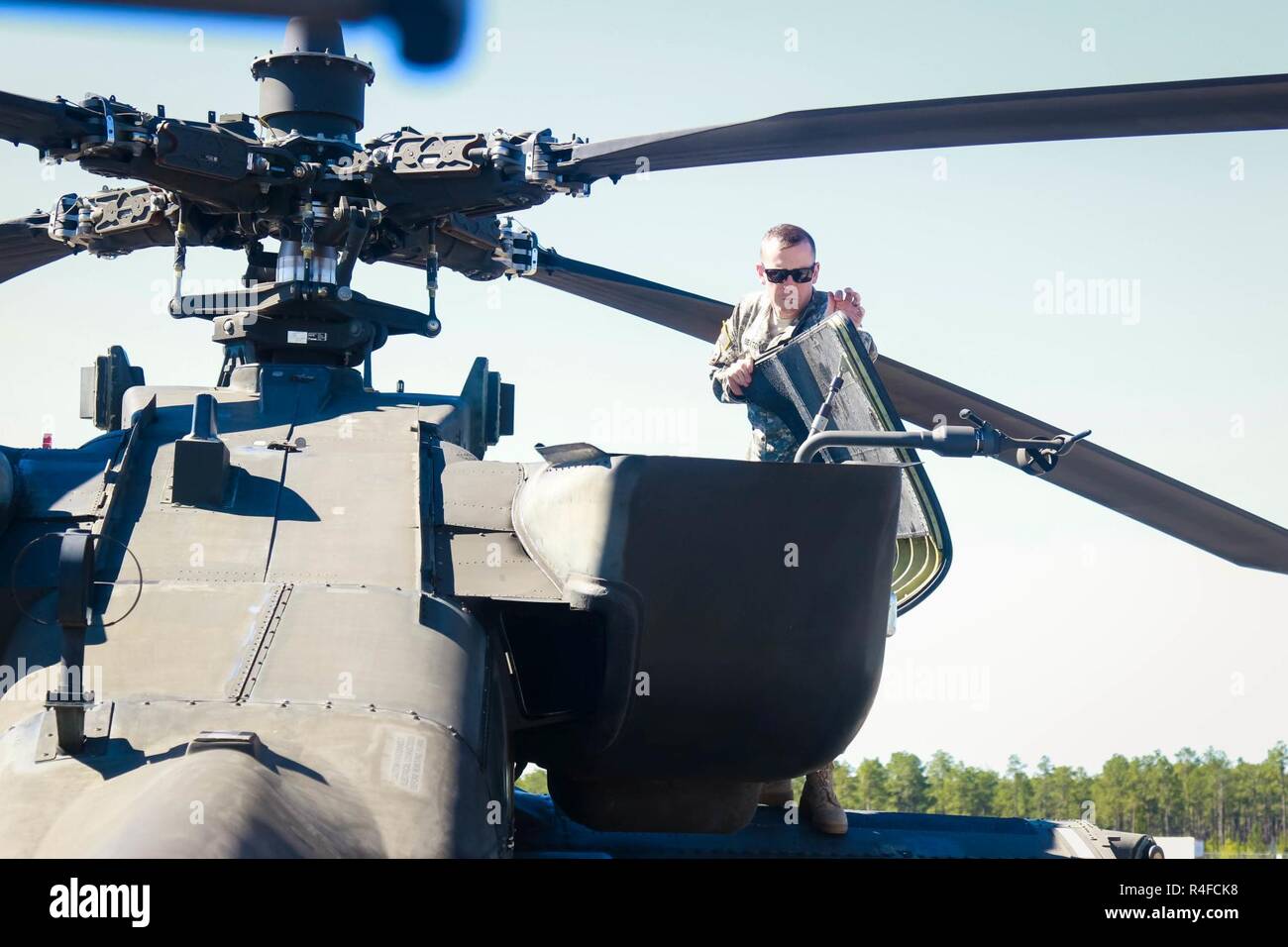 Chief Warrant Officer 2 Sexton assigned to 1st Attack Reconnaissance Battalion, 82nd Combat Aviation Brigade performs preflight checks on an AH-64 Apache helicopter before flight in support of a joint Combined Arms Live Fire Exercise on Fort Bragg, N.C., May 3. Stock Photo