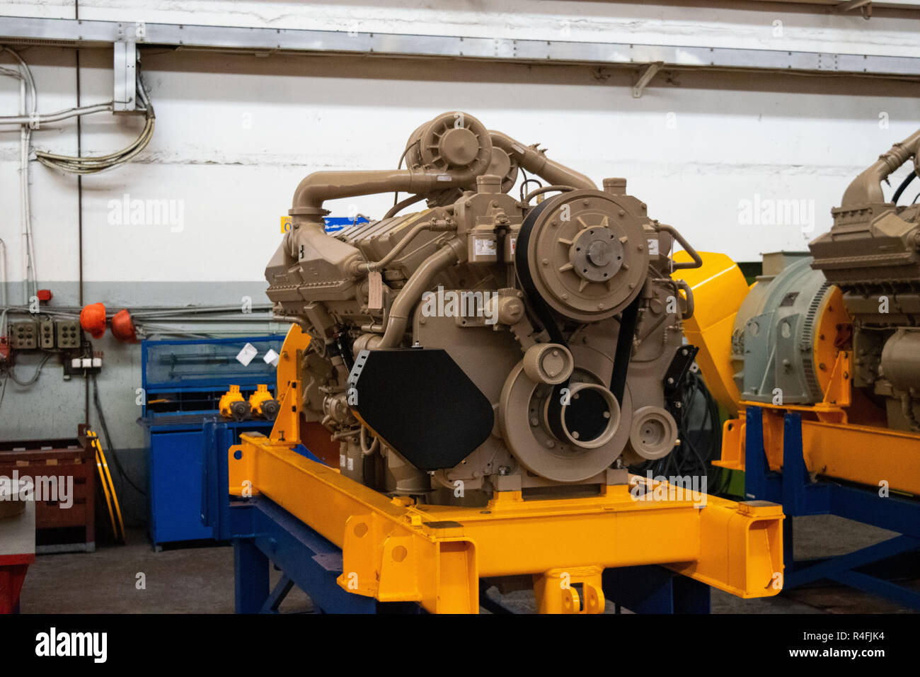 Large diesel engine with a huge turbine in the warehouse of finished