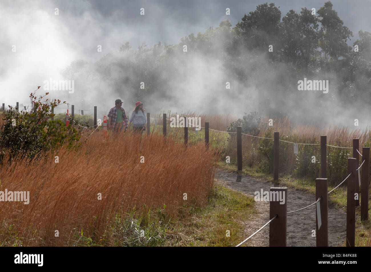 Hawaii Volcanoes National Park, Hawaii - Hikers on a trail at the edge