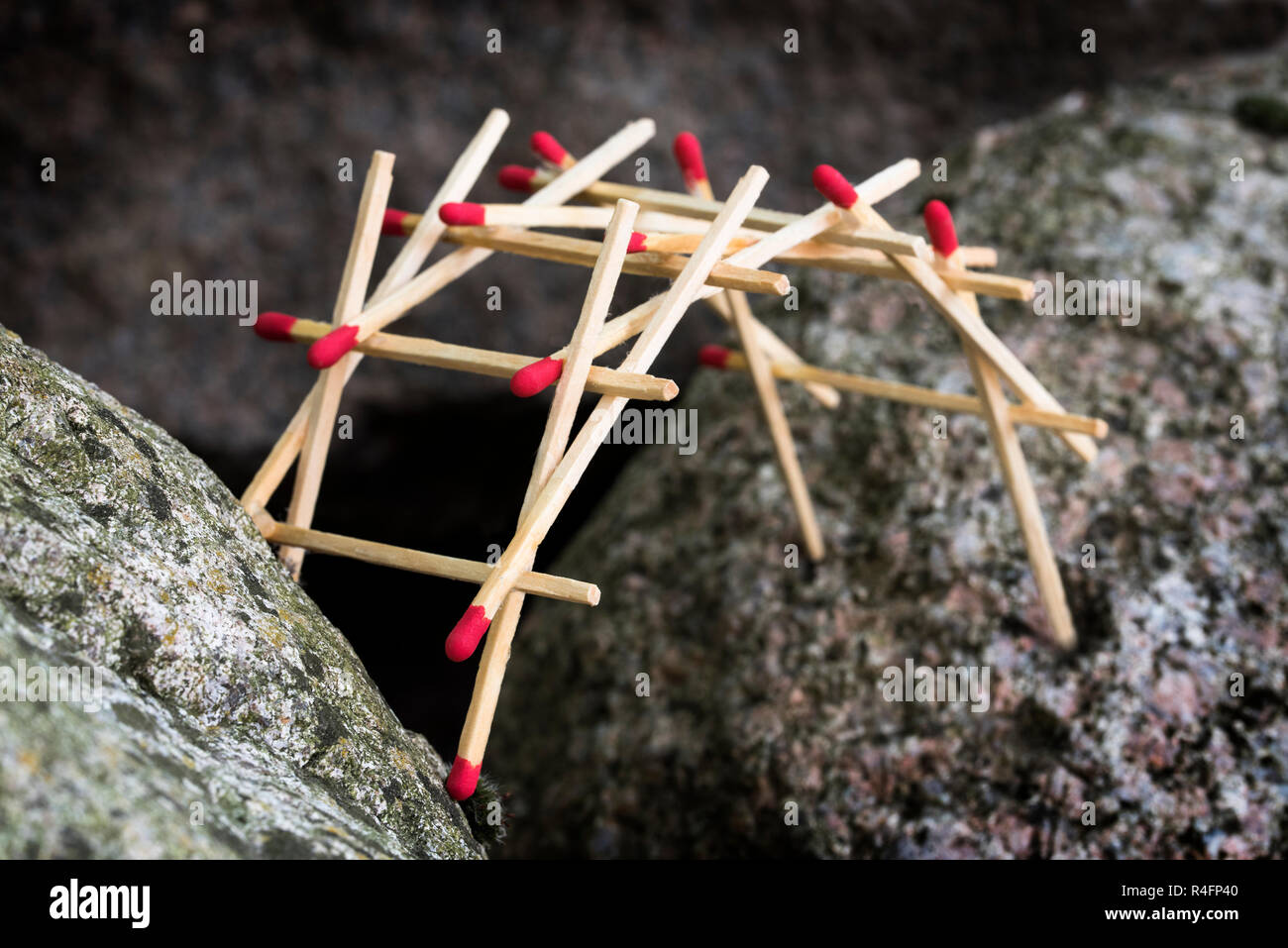 leonardo da vinci's self supporting bridge built from matches between big rocks, selected focus, narrow depth of field Stock Photo