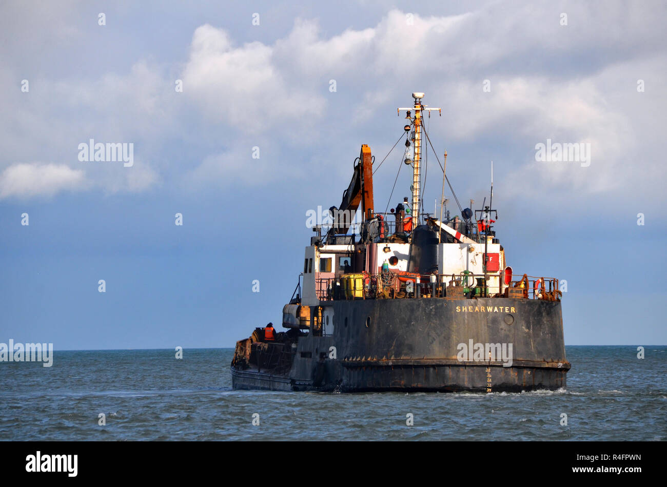 A dredging vessel at the mouth of Montrose harbour  Estuary, angus, Scotland Stock Photo