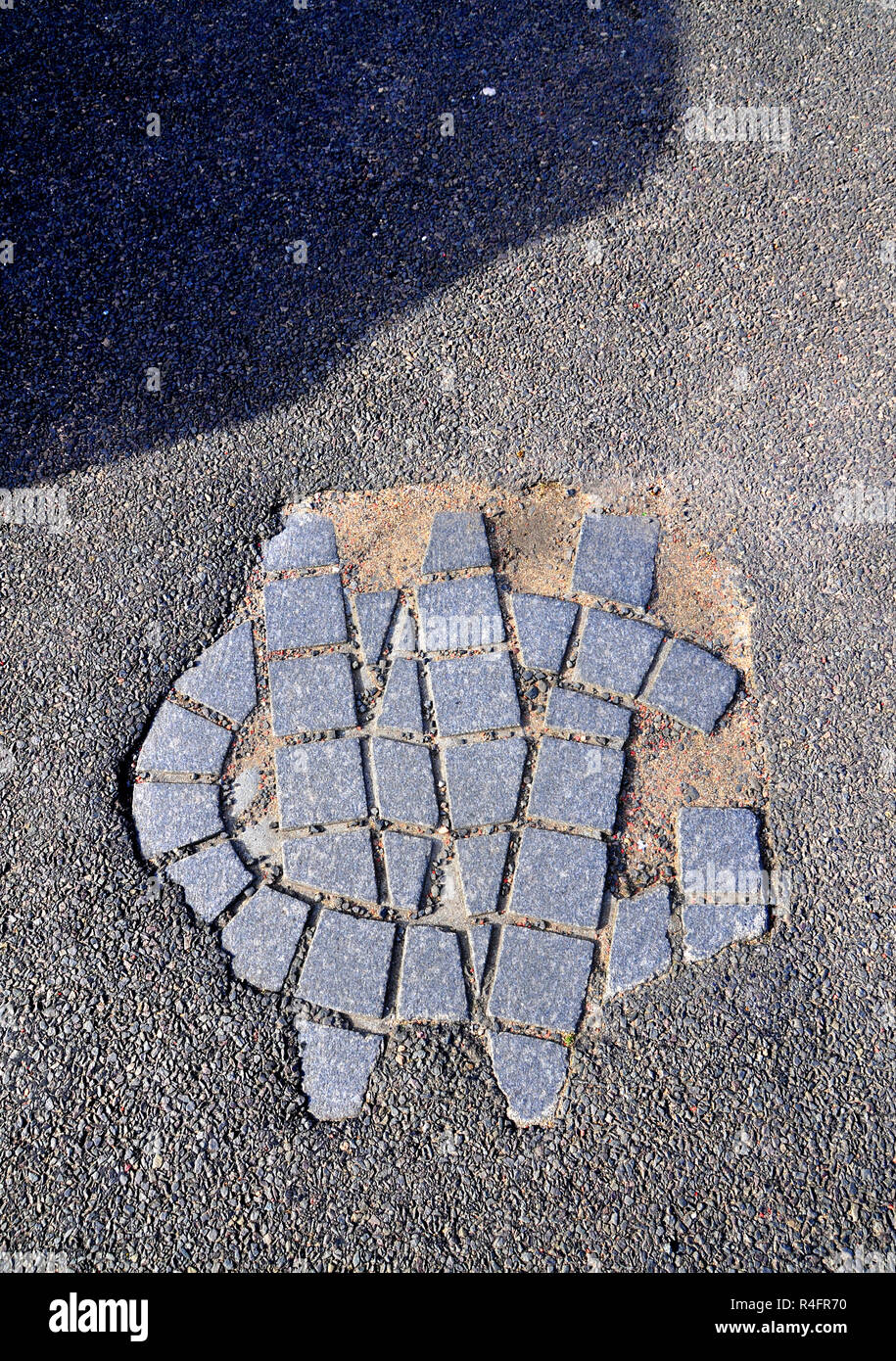 Paving markings GW of the place where the protestant reformer George Wishart was burned at the stake in the 16th century in St Andrews, Fife Scotland Stock Photo