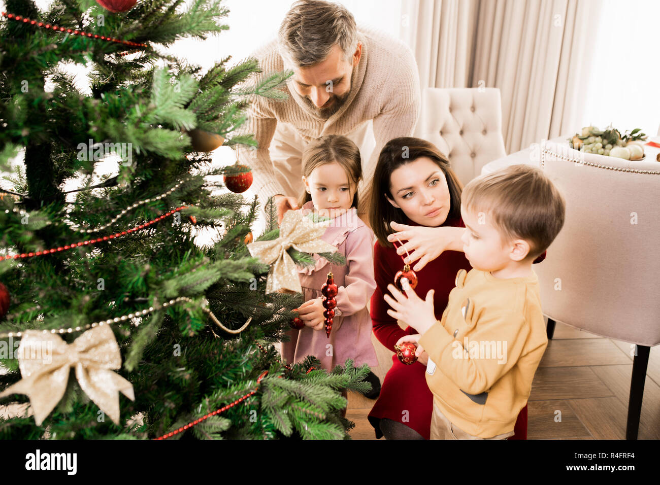 Family Decorating Christmas Tree Stock Photo