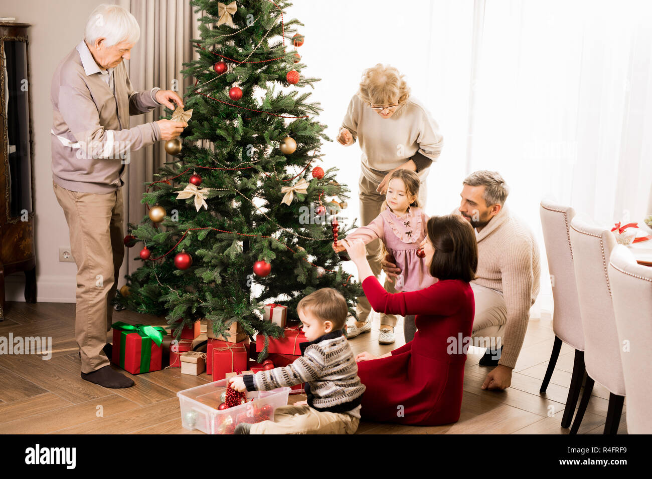 Big Family Decorating Christmas Tree Stock Photo - Alamy