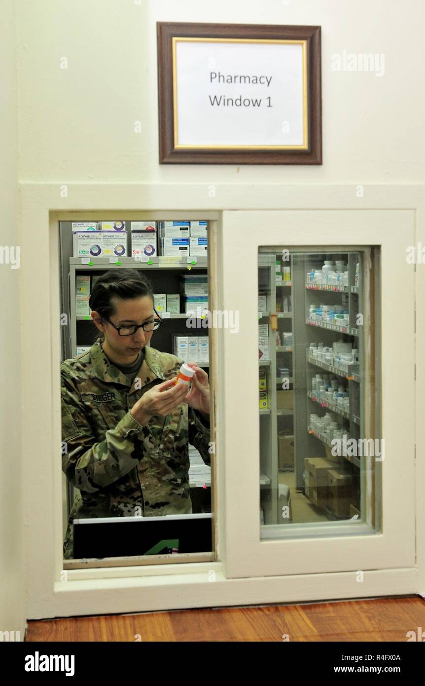 Capt. Sarah Steger, pharmacist with the 31st Combat Support Hospital and Olympia, Wa. native, verifies a prescription Oct. 25, 2016 at Camp Arifjan, Kuwait. Kim along with a small team of Soldiers operate the 31st CSH pharmacy providing pharmaceutical support to patients suffering from injuries and illnesses throughout the ARCENT area of operations. The team processes more than 3,500 outpatient prescriptions a month to service members and civilians while providing support to inpatient care and other facilities throughout the region. Stock Photo