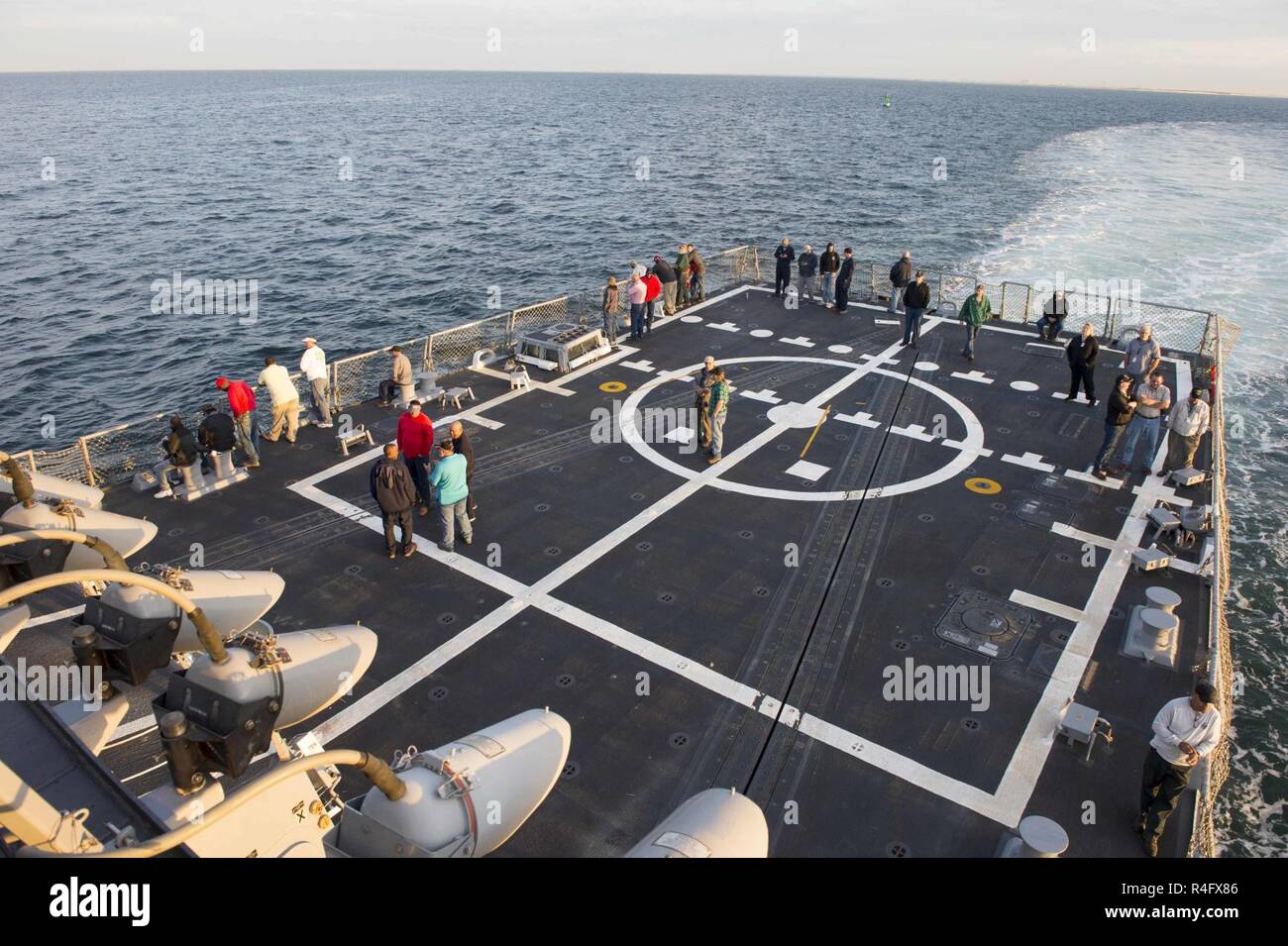 GULF OF MEXICO (Oct. 24, 2016) Civilians from numerous organizations gather on the flight deck of pre-commissioning unit John Finn (DDG 113) during builder’s trials, Oct, 24.  John Finn, built by Huntington Ingalls Shipbuilding, will conduct the final phase of trials, known as acceptance trials, in early November. Stock Photo