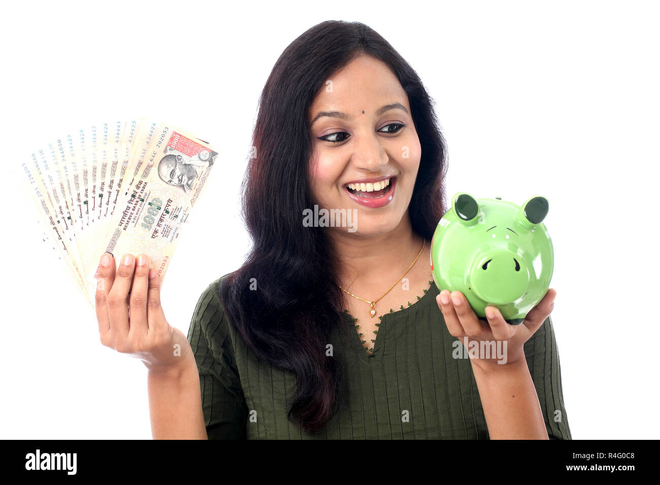 Young Indian Woman Saves Money in Piggy bank Stock Photo - Alamy