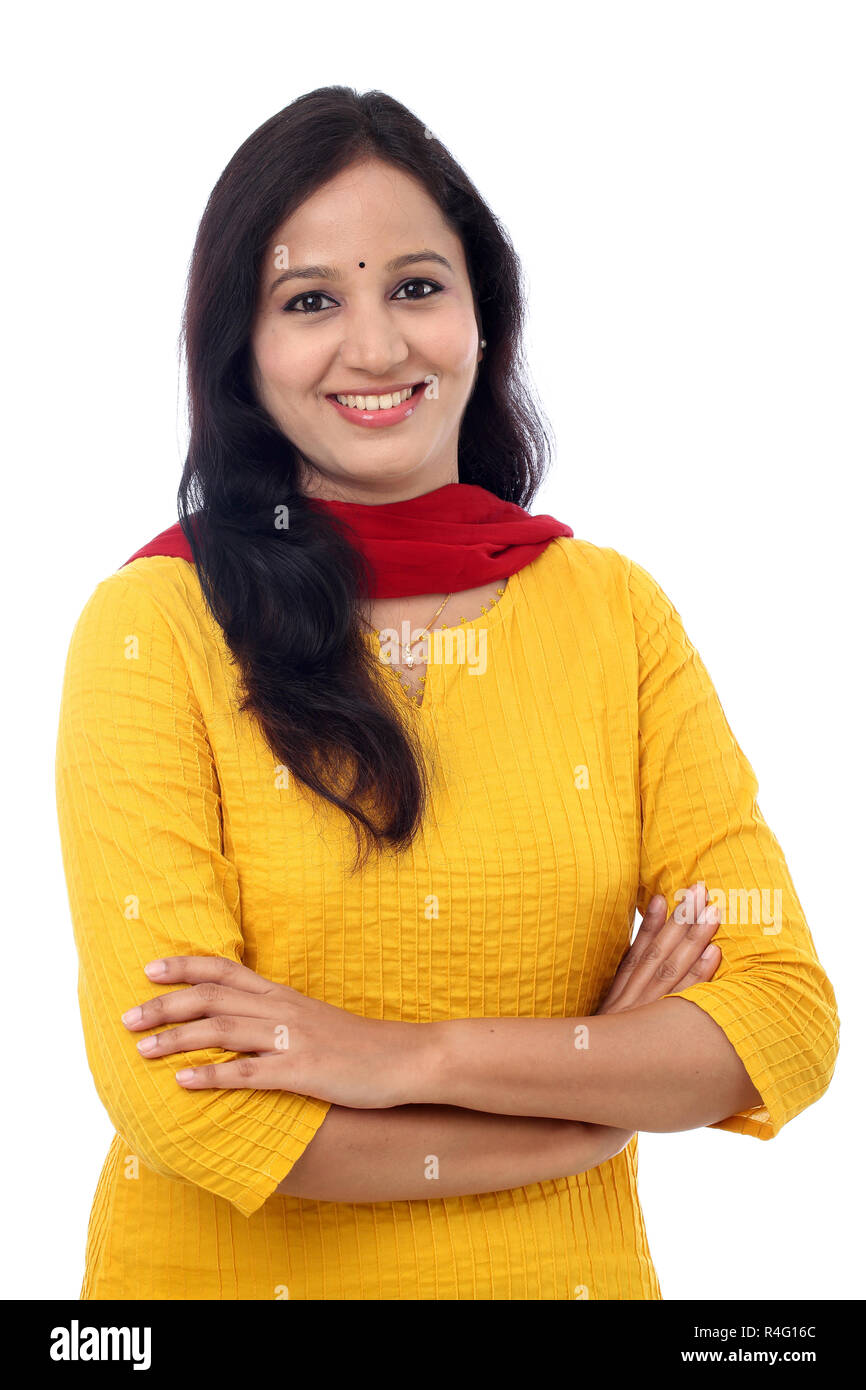 Smiling young woman with arms crossed against white Stock Photo - Alamy