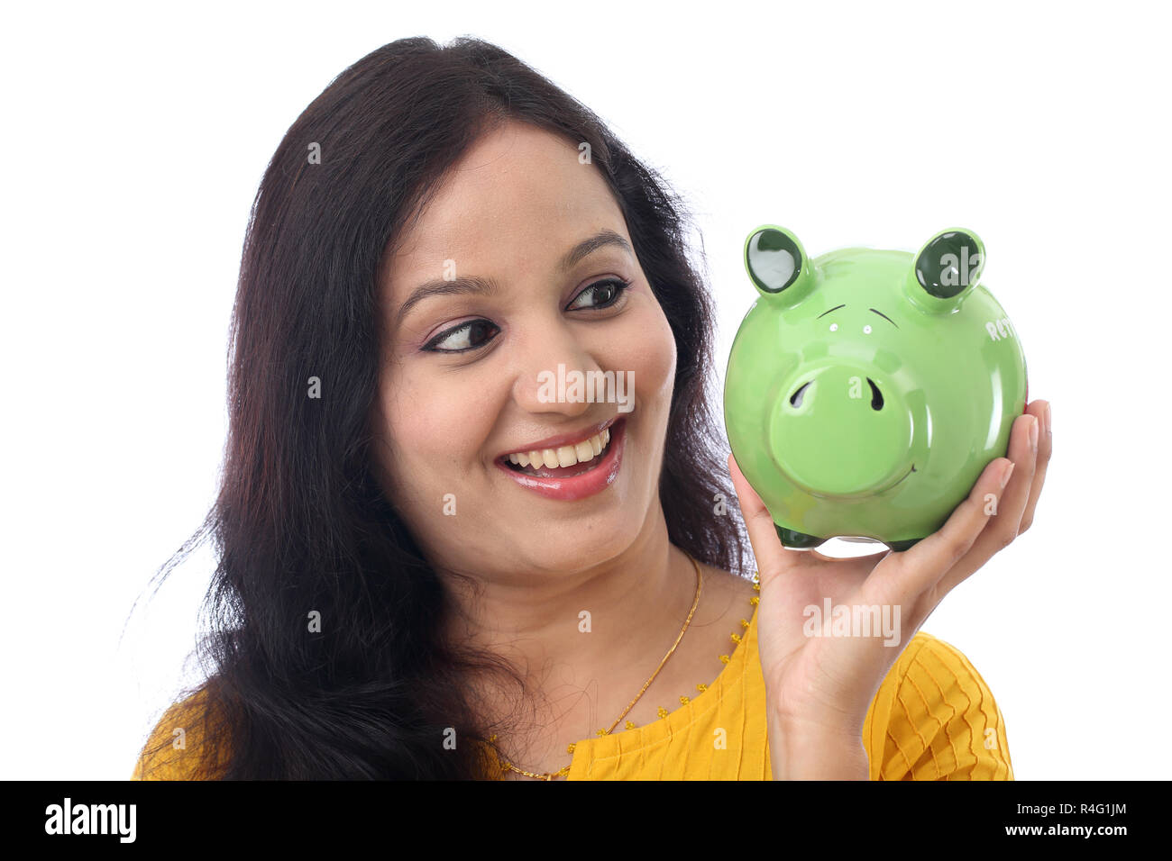 Young Indian Woman Saves Money in Piggy bank Stock Photo - Alamy