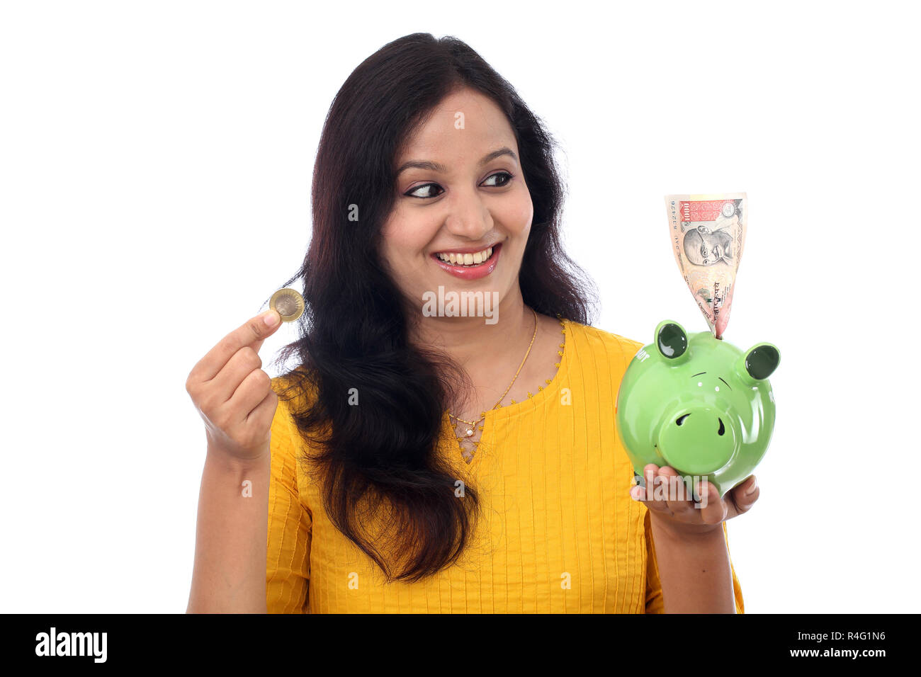 Young Indian Woman Saves Money in Piggy bank Stock Photo - Alamy