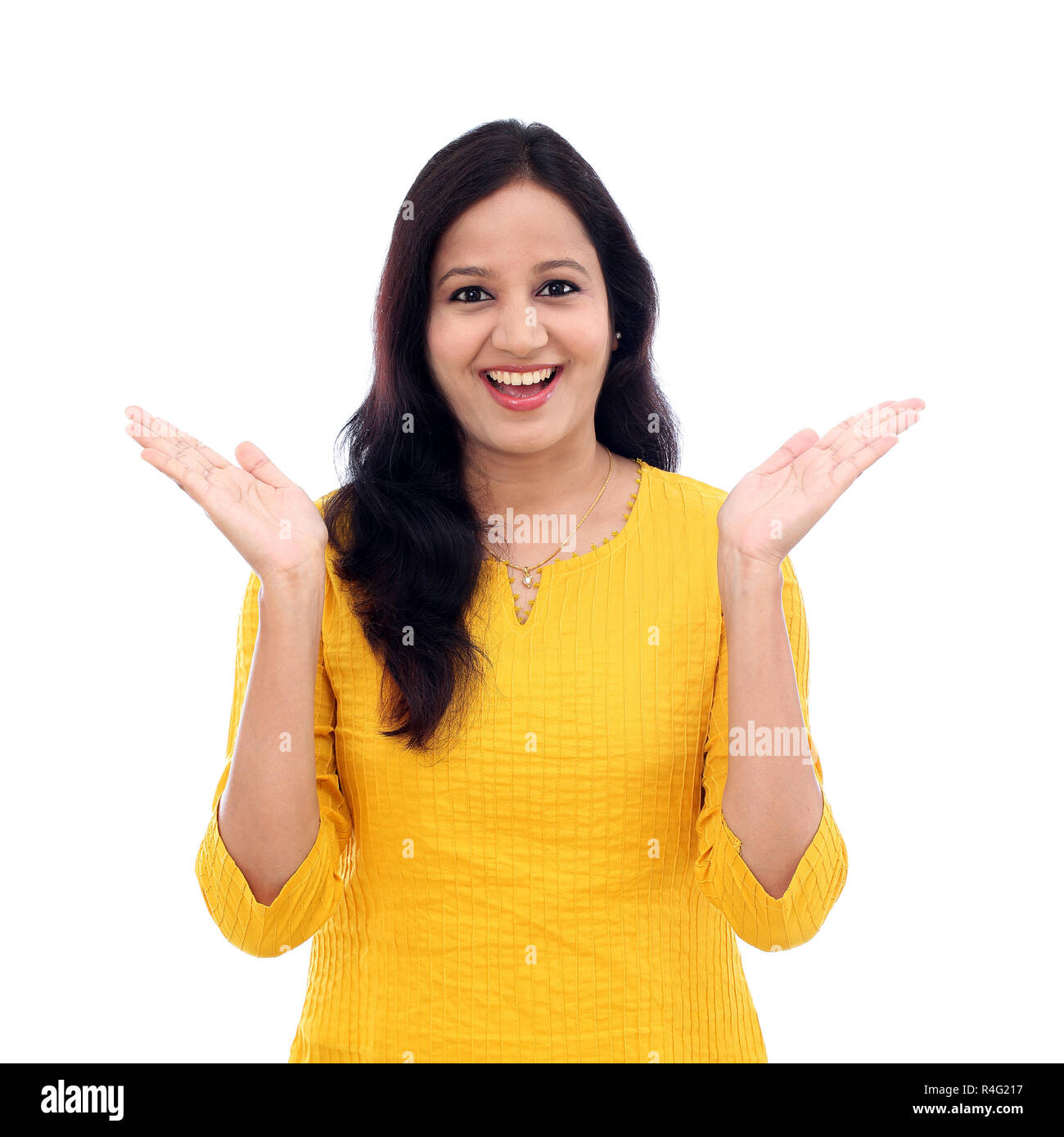 Surprised young woman against white background Stock Photo - Alamy