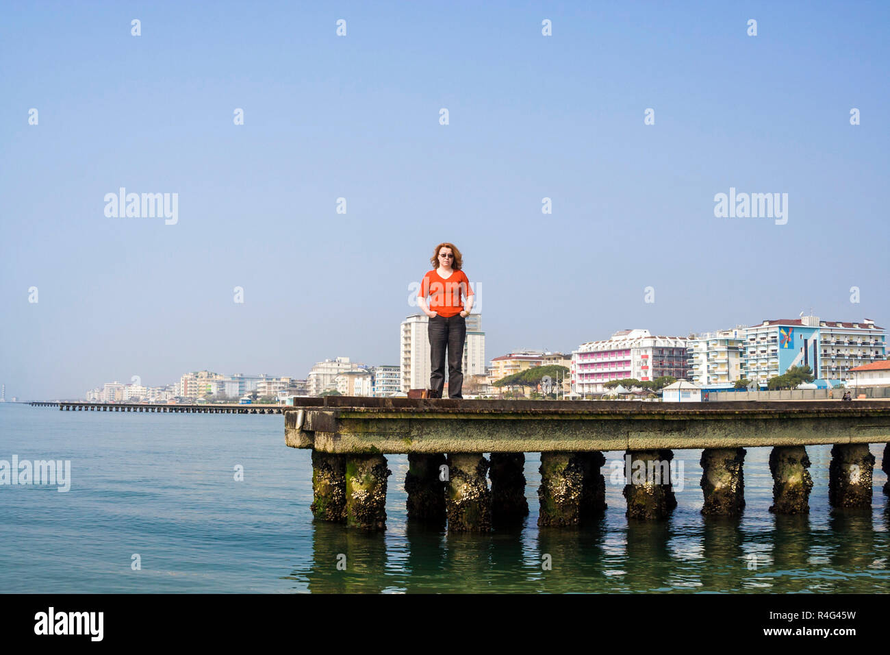 woman on a pier in Venice, Italy Stock Photo