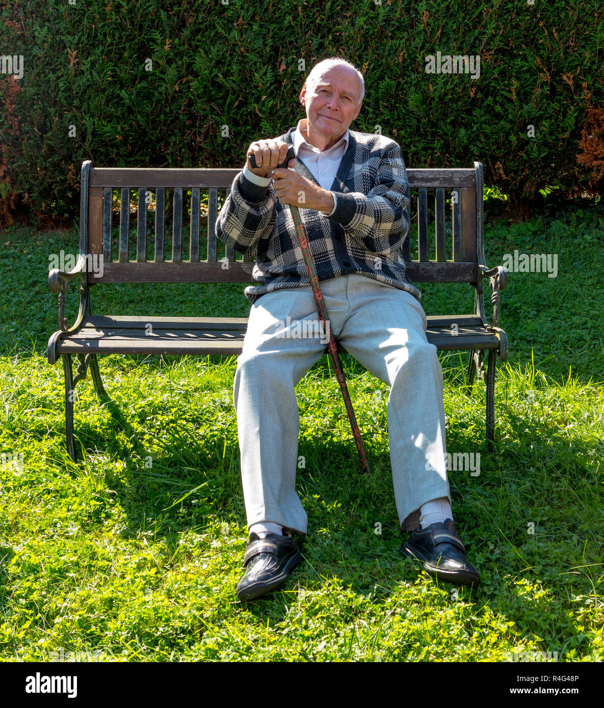 old man enjoys sitting on a bench in his garden Stock Photo - Alamy