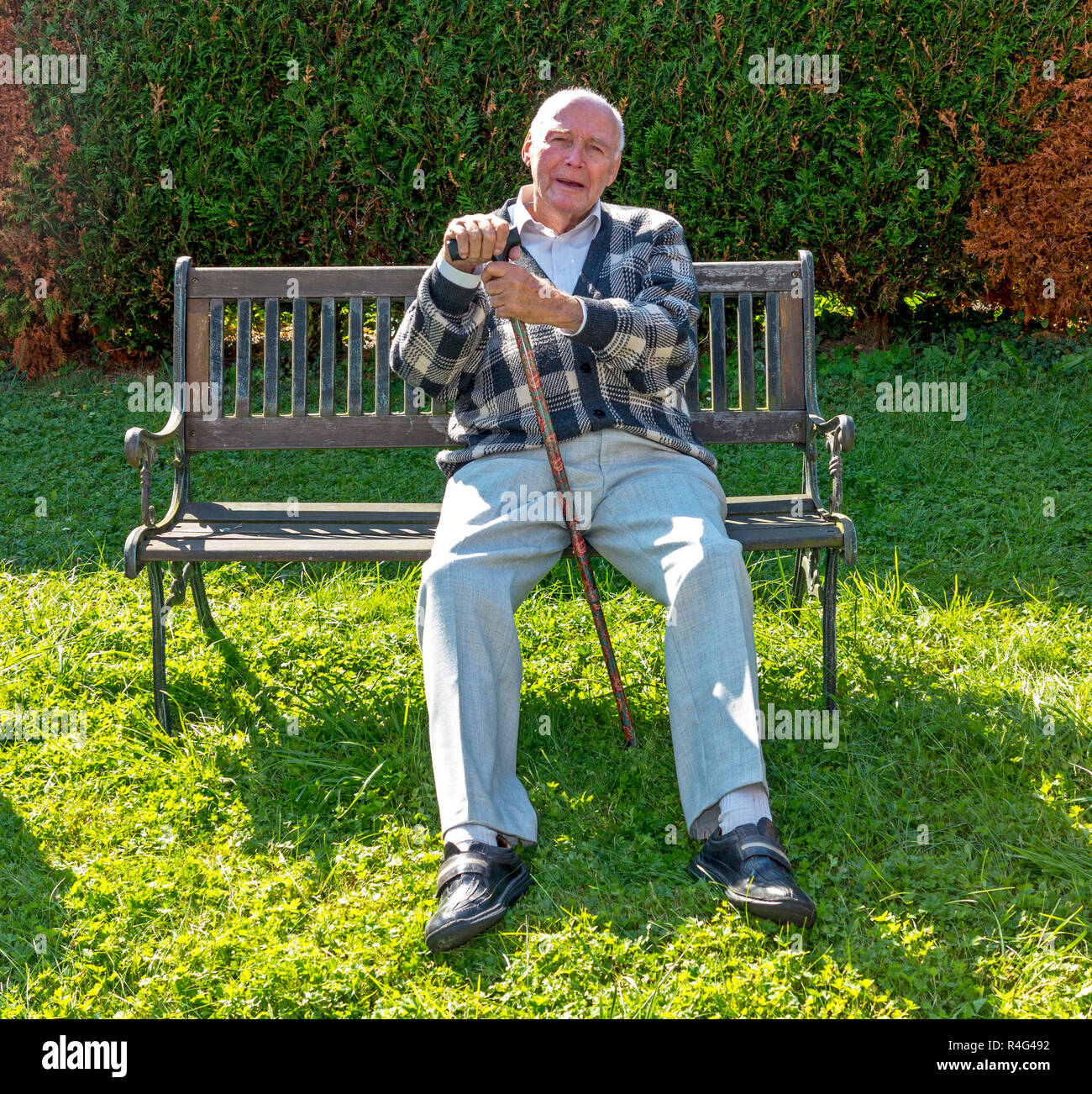 old man enjoys sitting on a bench in his garden Stock Photo - Alamy