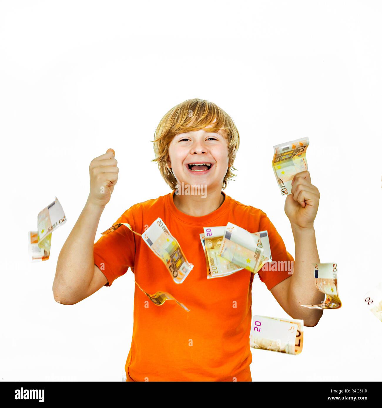 Euros flying around a boys head Stock Photo