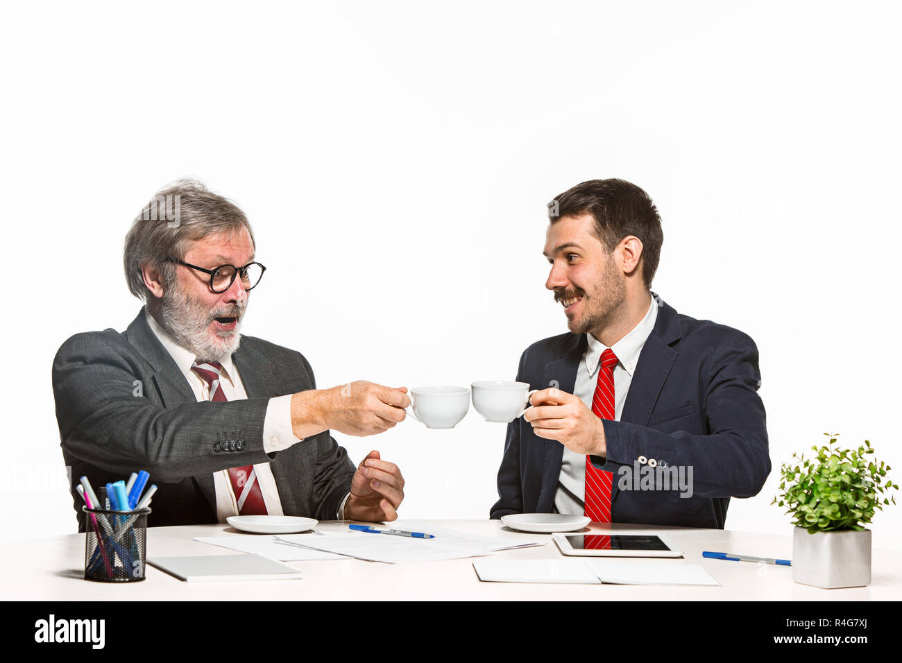 Two Team Members The two colleagues working together at office on white background Stock ...