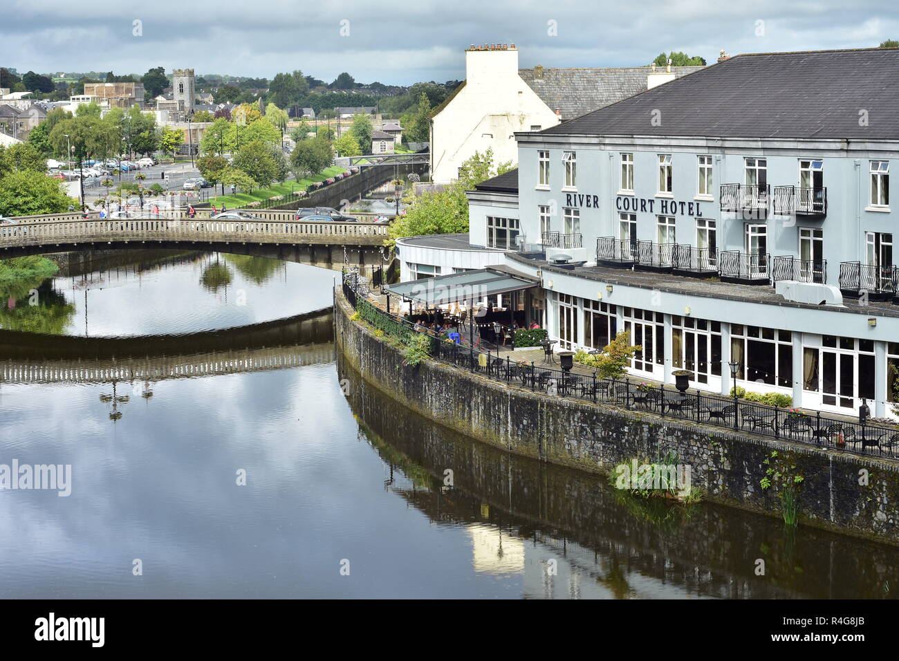 River Court Hotel on River Nore in Kilkenny on calm day when river surface mirrors surroundings. Stock Photo