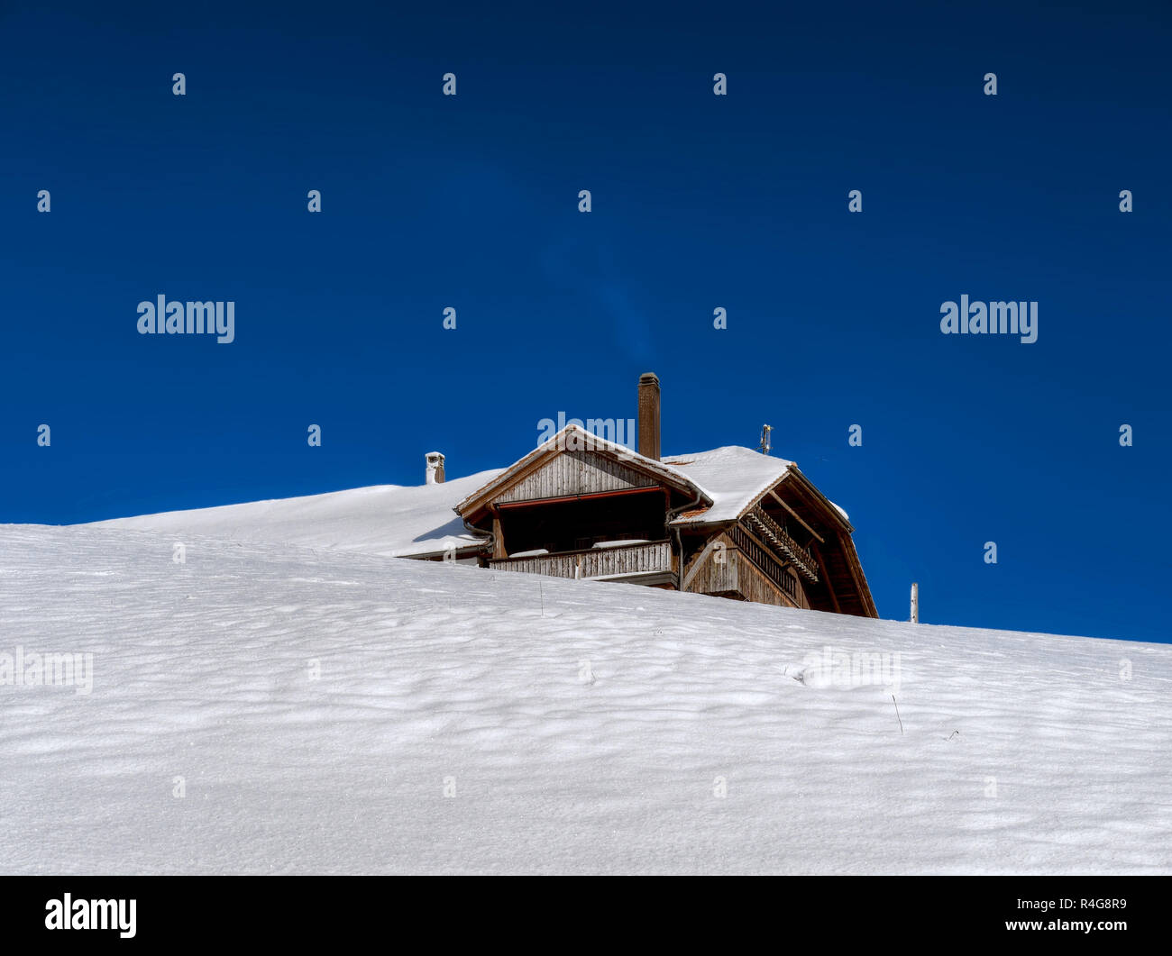 Typical chalet house in Switzerland near Schwarzsee in Winter, Fribourg region Stock Photo