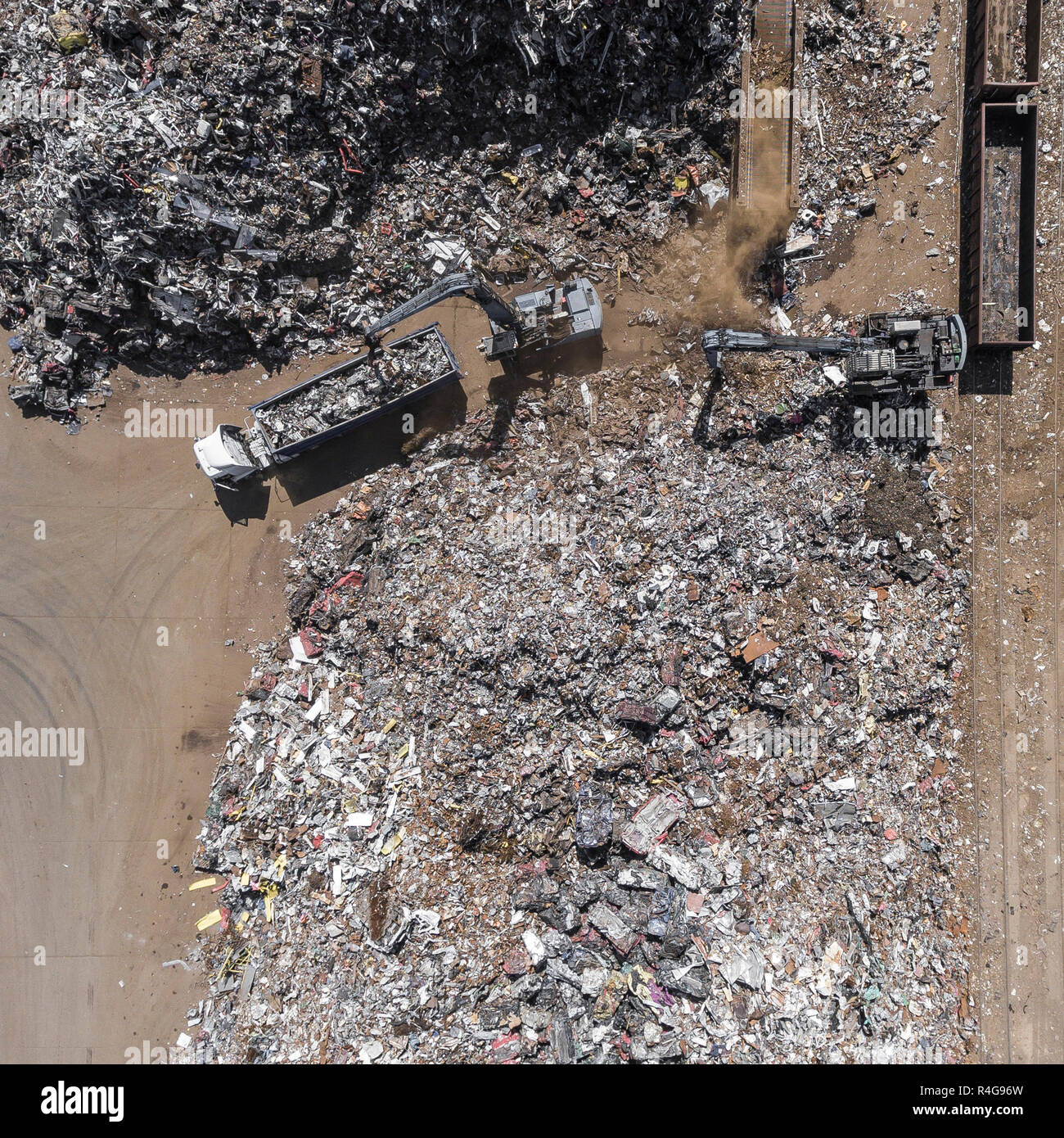 Iron raw materials recycling pile, work machines. Metal waste junkyard ...