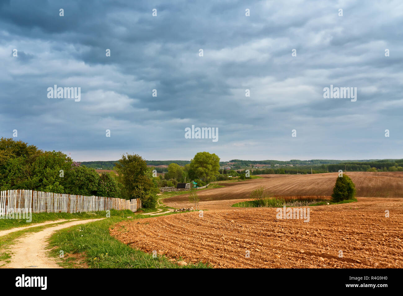 Spring storm clouds above country road Stock Photo - Alamy