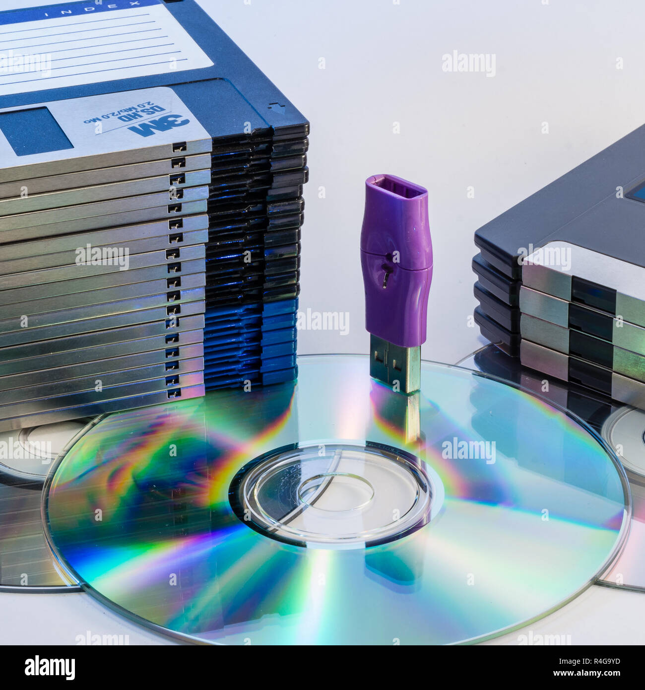 Progression of computer data storage media from floppy to USB flash stick through the DVD rom Stock Photo