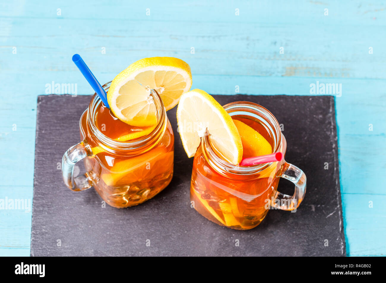Iced tea in a glass jar with lemon Stock Photo Alamy